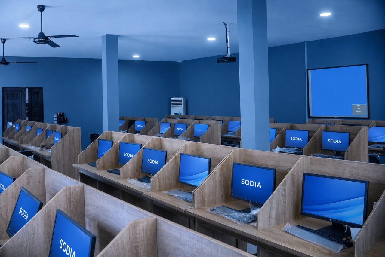 Two women focused on their computer screens in an office setting.